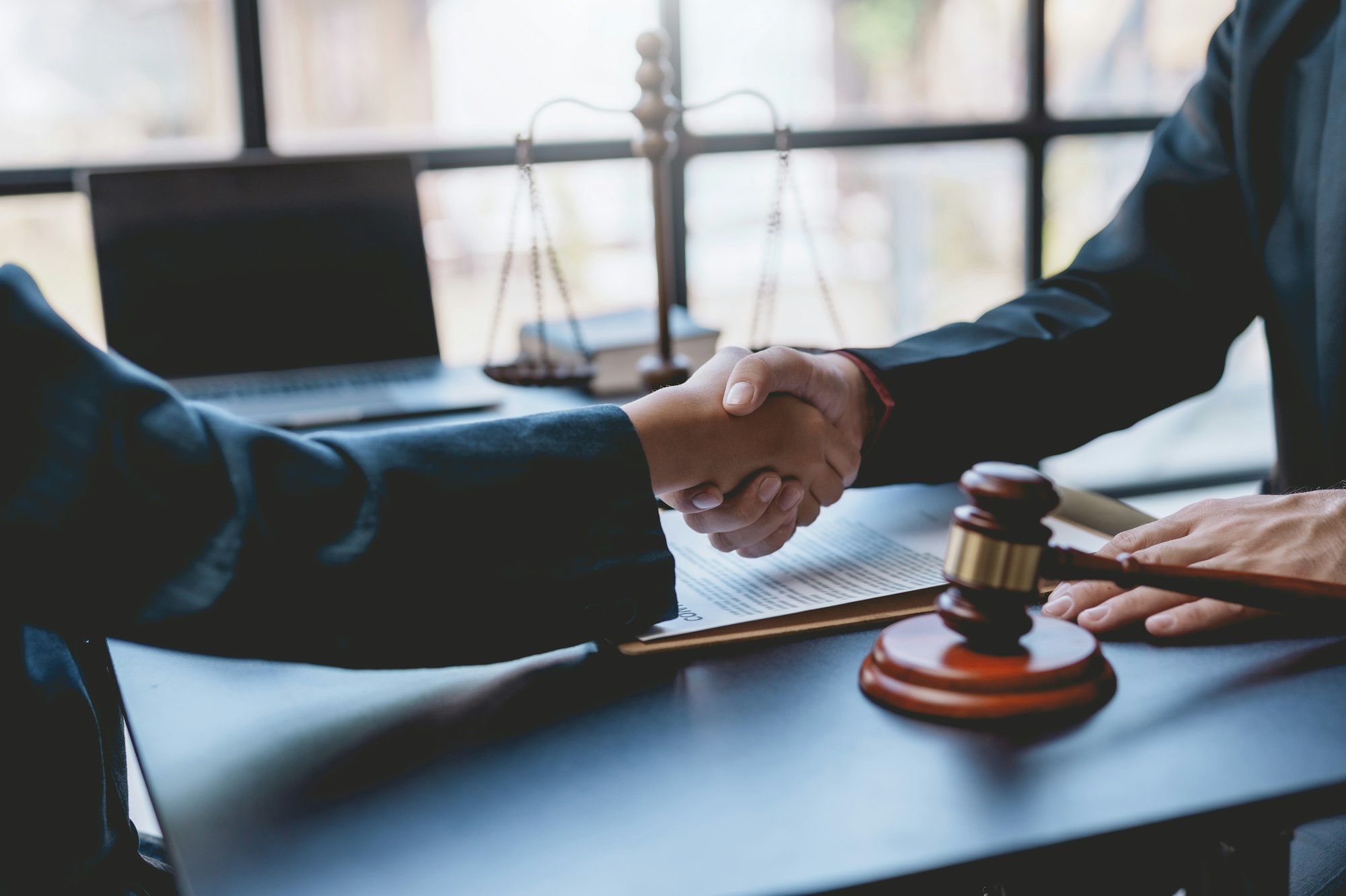 Businessman handshake to seal a deal with his partner lawyers or attorneys
